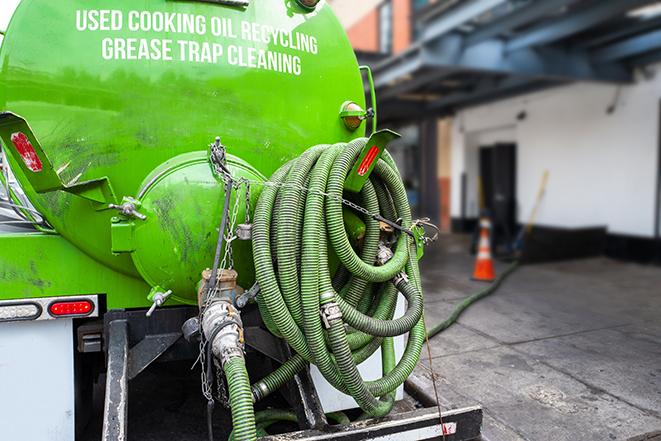 a grease trap pumping truck at a restaurant in Excelsior